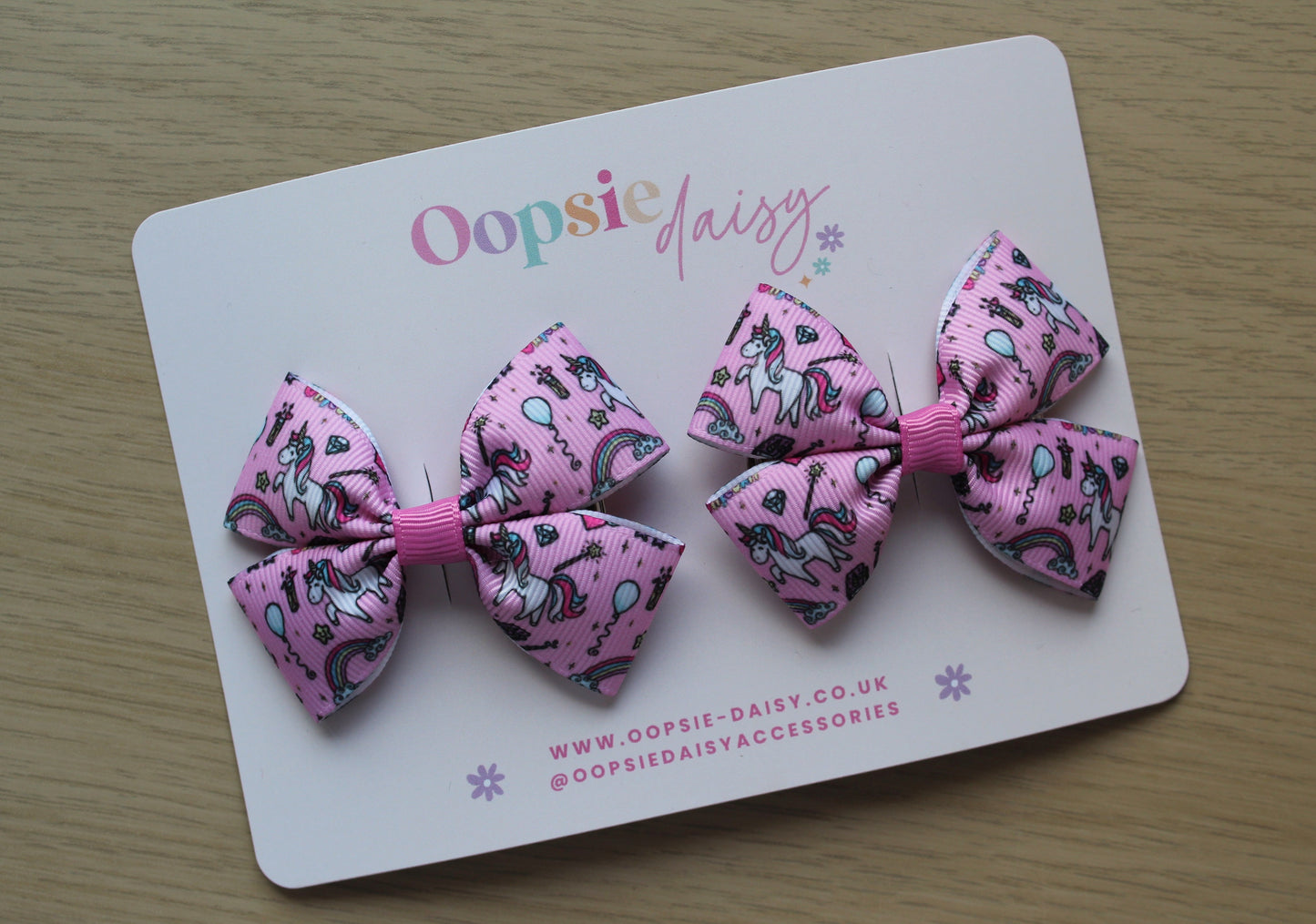 Pair pink hair bows with unicorn design
