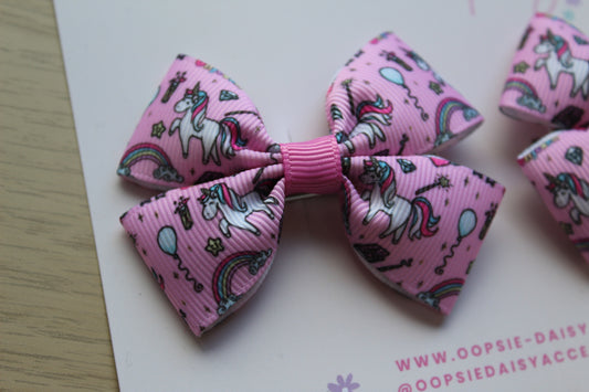 Pink hair bow with unicorn design