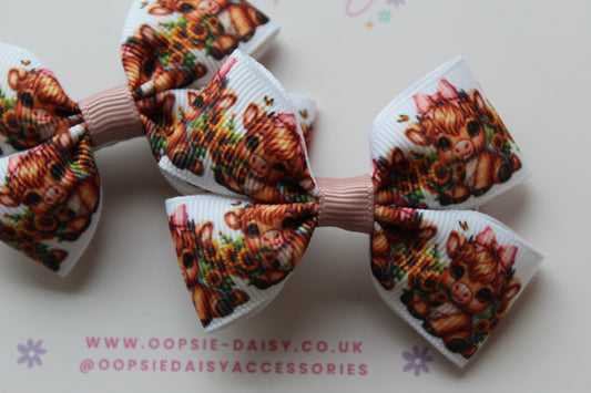 Pair hair bow clips with baby cow design