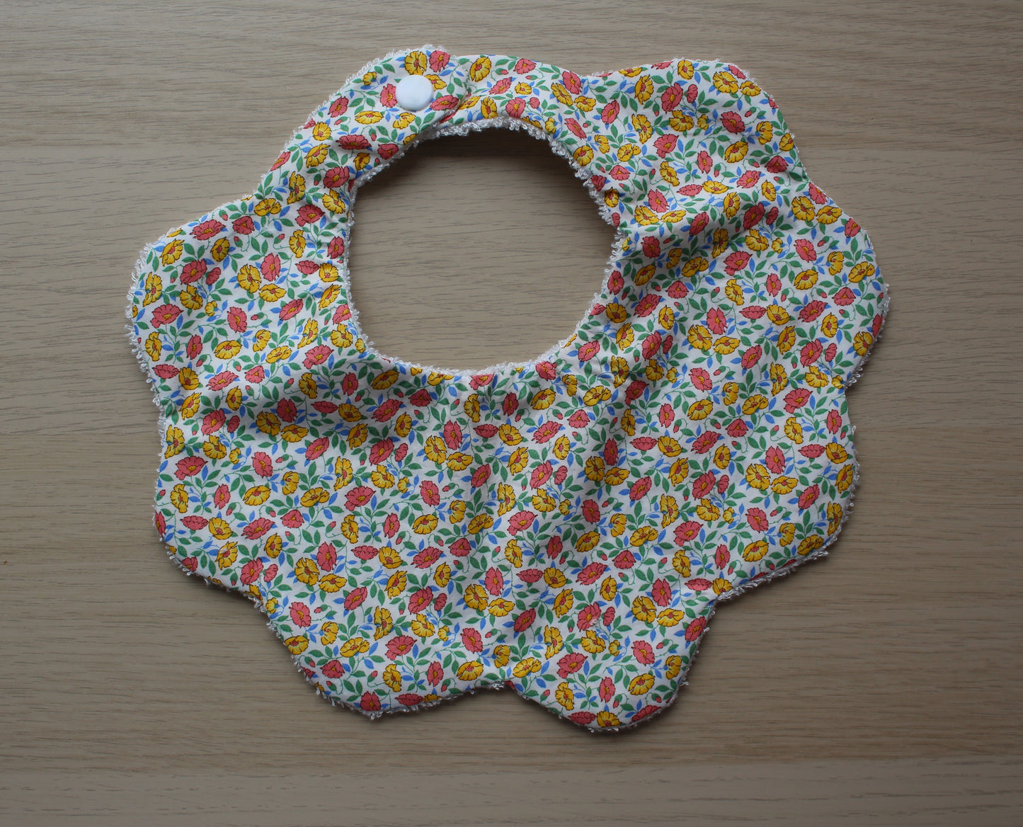 Scallop shaped baby bib with Liberty floral pattern