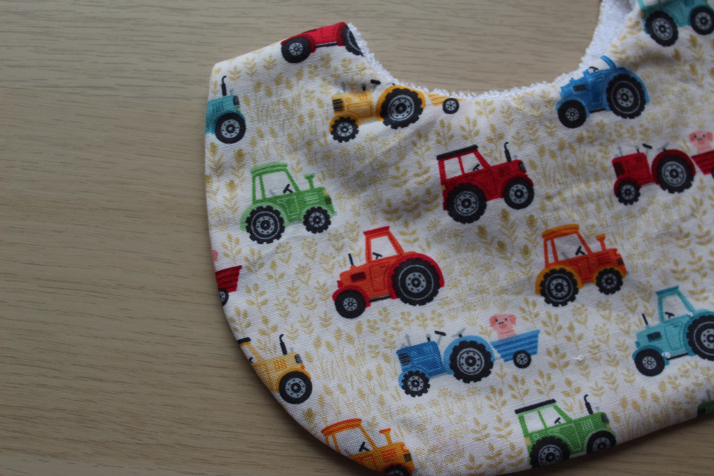 Baby bib with cute tractor farmyard design