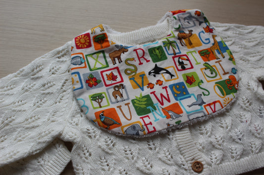 Alphabet themed baby bib with animal motifs