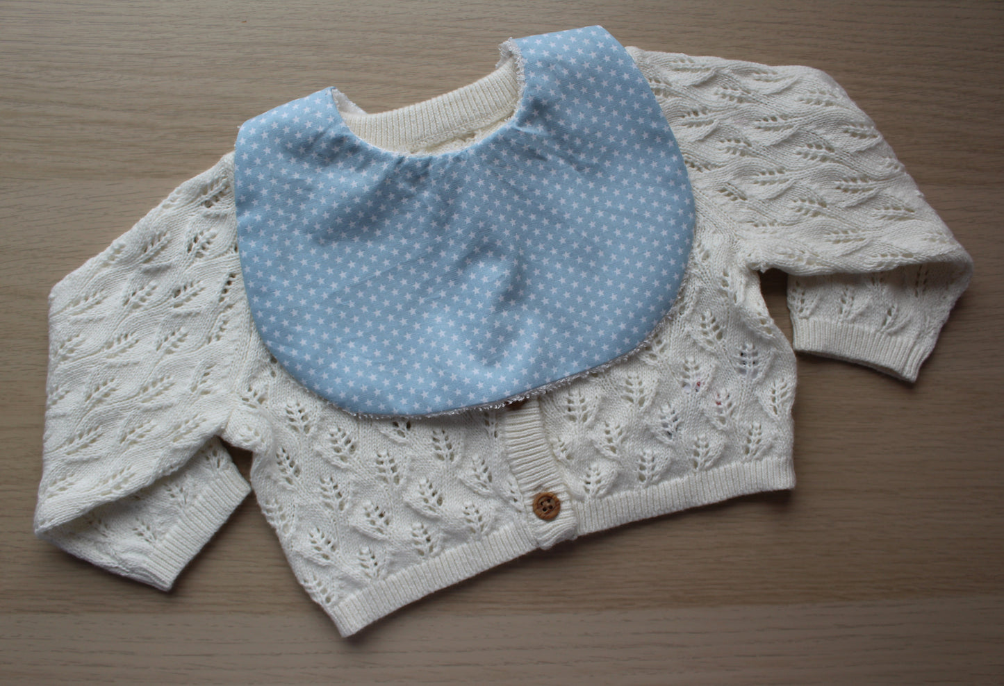 Baby bib featuring small stars on a blue background