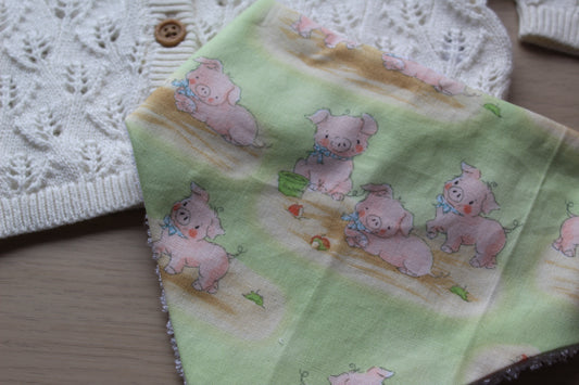 Baby dribble bib featuring little pigs