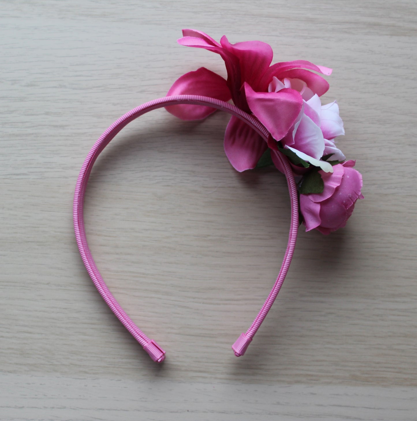 Pink floral headband on a deep pink band