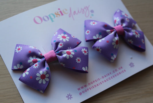 Hair clips with pink and purple daisy flowers