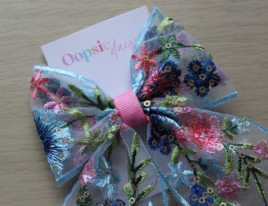 Hair bow with blue and pink floral embroidery