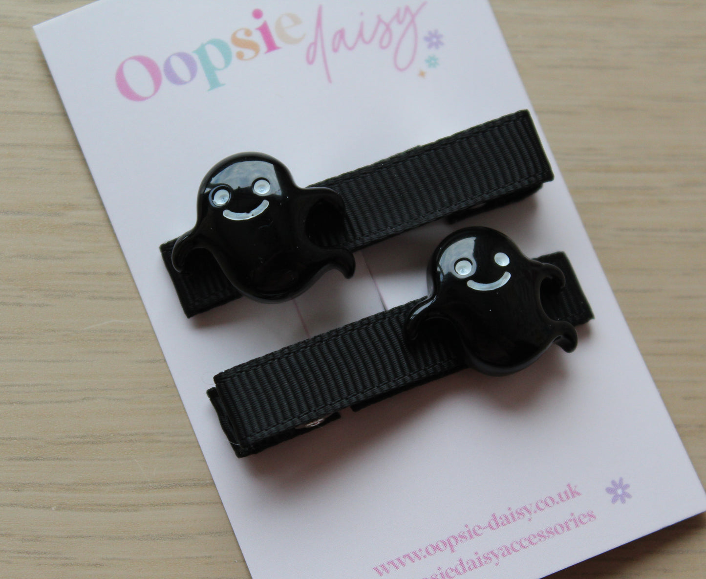Hair clips with black ghost design