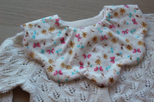 Scallop baby bib with pretty ditsy butterfly and floral design