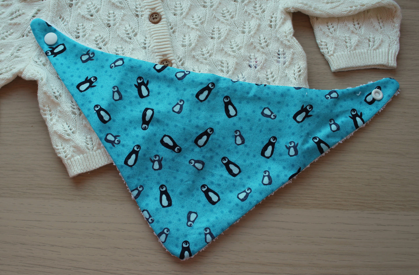 Festive penguin baby bib