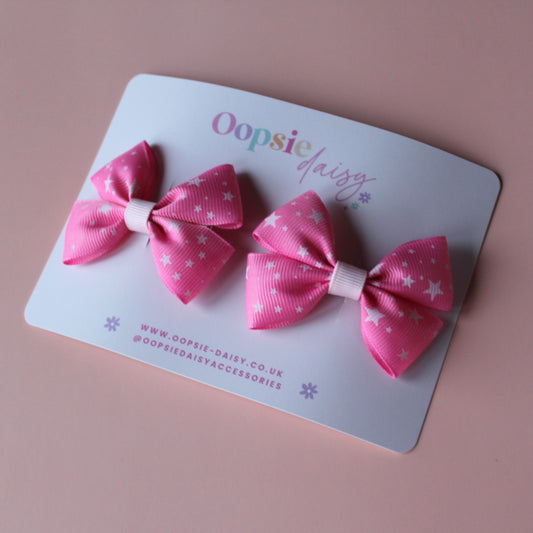 Pair hair bows in pink with small white stars