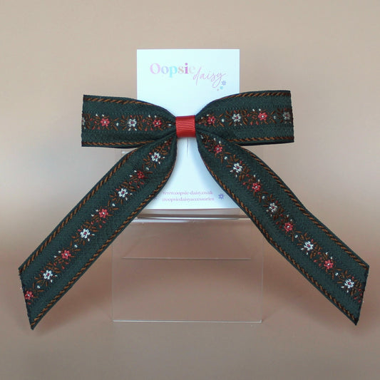 Khaki hair bow with rust orange and cream floral pattern
