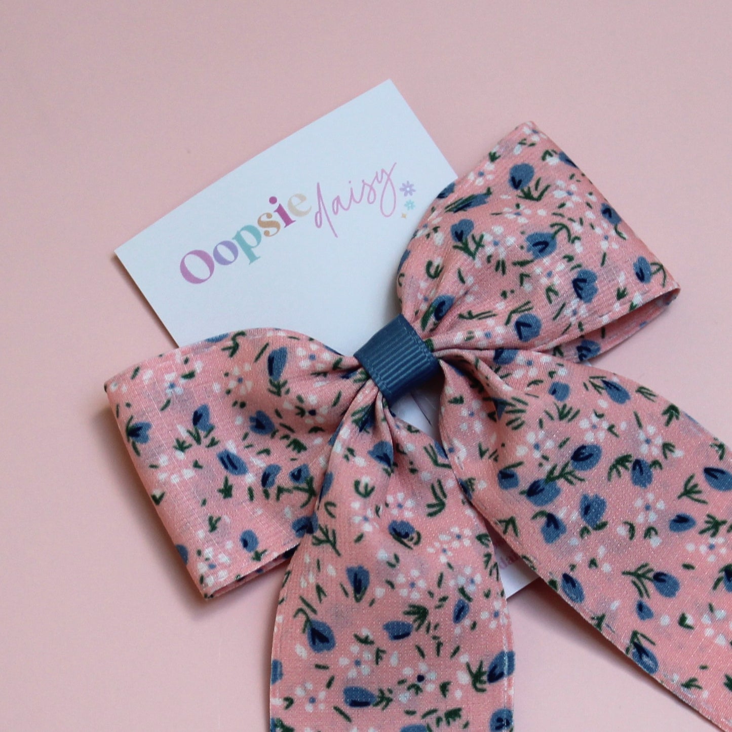 Pink hair bow with ditsy blue flowers