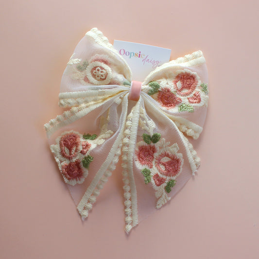 Sheer lace hair bow with cream and pink embroidered flowers