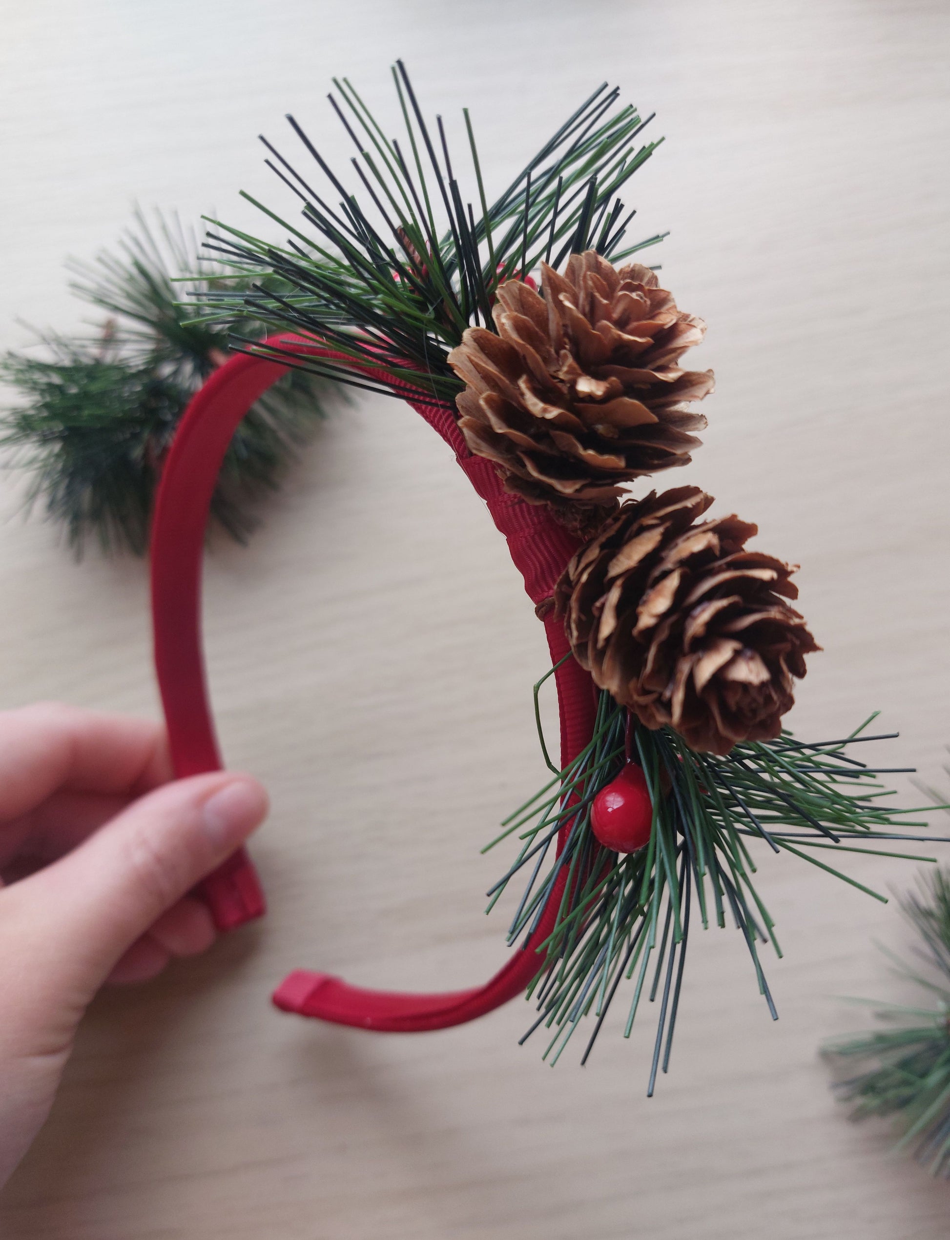 Festive headband with pine cones and foliage