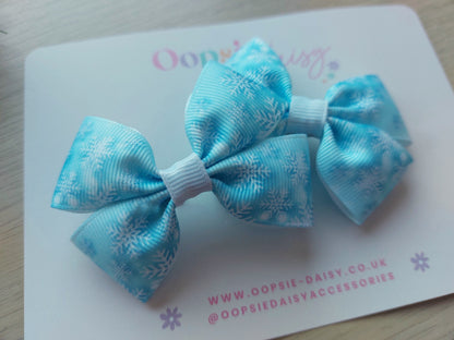 Two blue snowflake hair bows