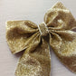 Festive gold shimmer glitter hair bow