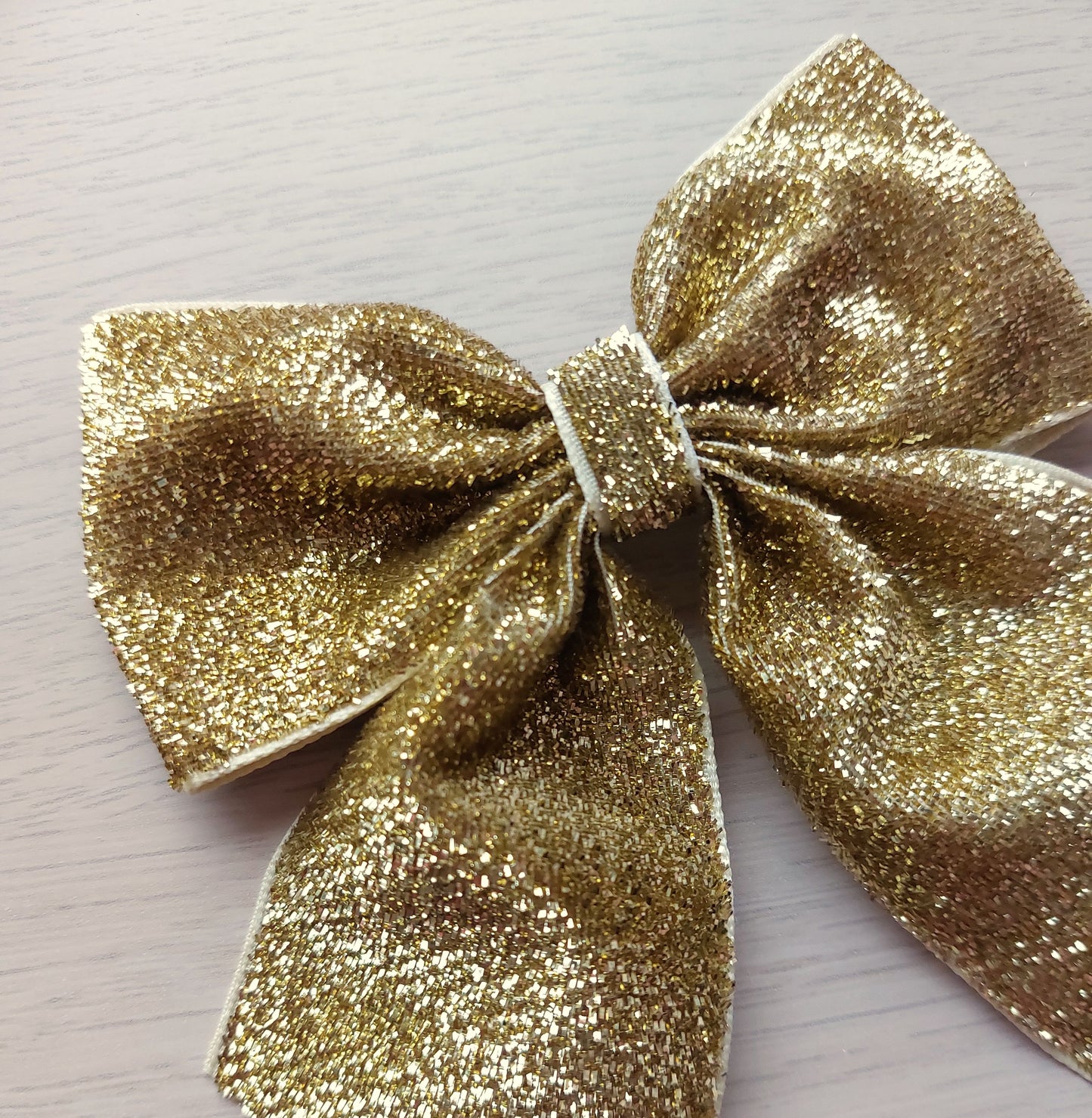 Festive gold shimmer glitter hair bow