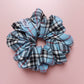 Tartan oversized hair scrunchie in light blue with black and red checks. 
