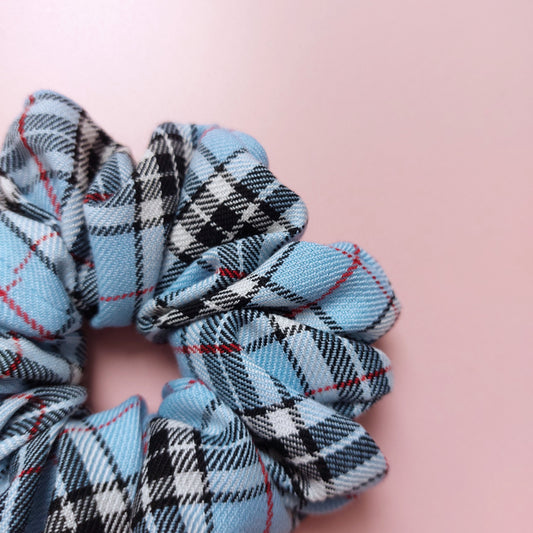 Tartan oversized hair scrunchie in light blue with black and red checks. 