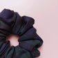Oversized Black Watch tartan hair scrunchie made from dark green and navy tartan fabric. 