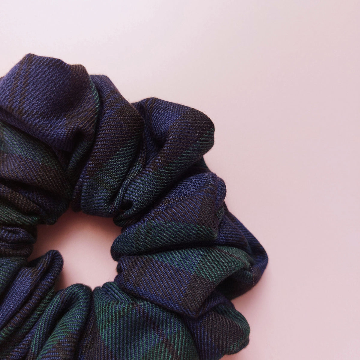 Oversized Black Watch tartan hair scrunchie made from dark green and navy tartan fabric. 