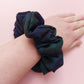 Oversized Black Watch tartan hair scrunchie made from dark green and navy tartan fabric. 
