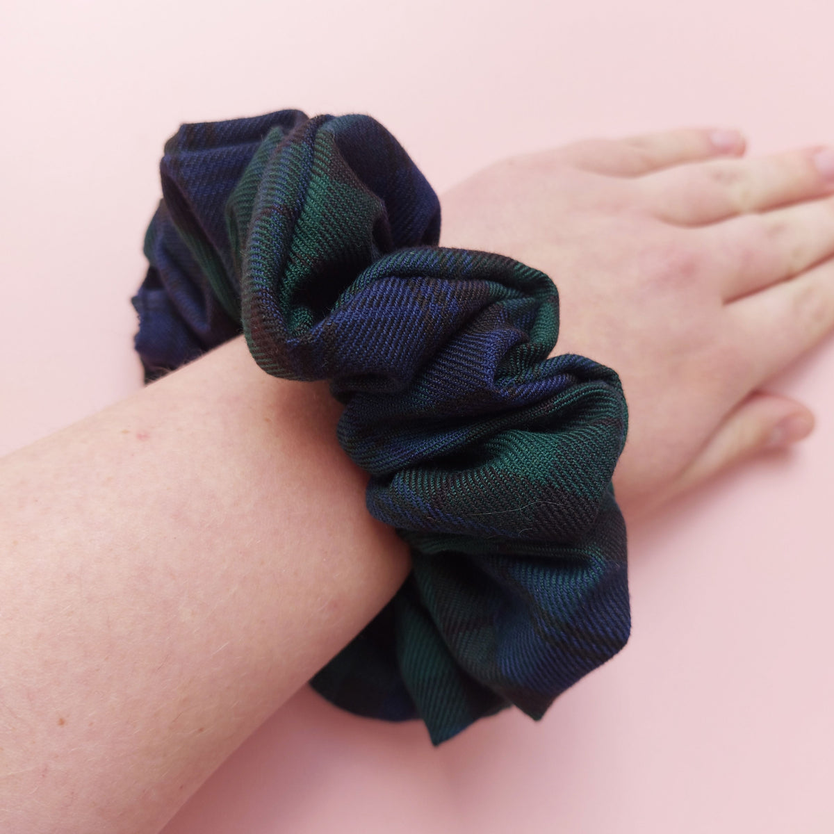 Oversized Black Watch tartan hair scrunchie made from dark green and navy tartan fabric. 