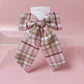 Long tartan hair bow in light pink with beige, white and burgundy  checks