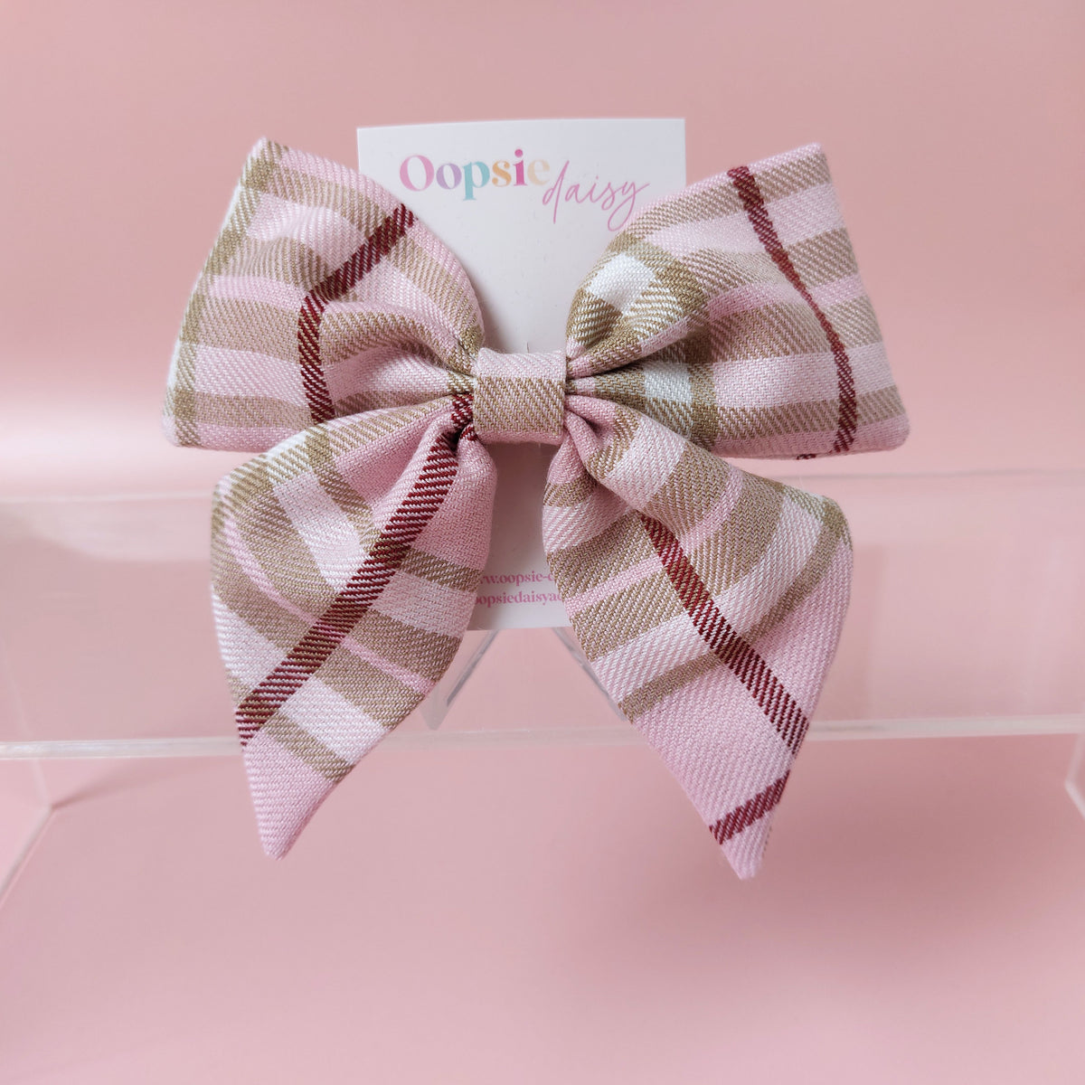 Light pink tartan hair bow with beige, white and burgundy checks. 
