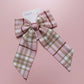 Long tartan hair bow in light pink with beige, white and burgundy  checks