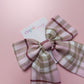 Long tartan hair bow in light pink with beige, white and burgundy  checks