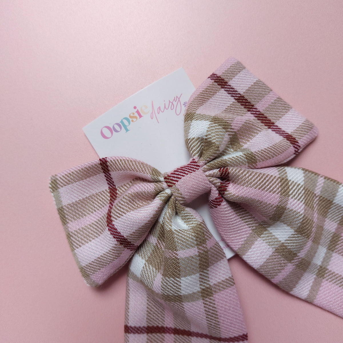 Long tartan hair bow in light pink with beige, white and burgundy  checks