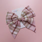 Light pink tartan hair bow with beige, white and burgundy checks. 
