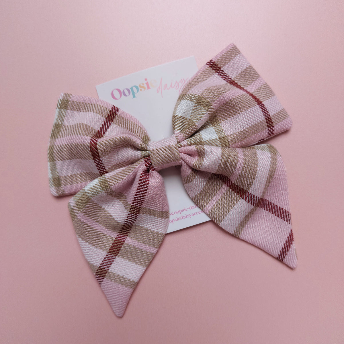 Light pink tartan hair bow with beige, white and burgundy checks. 