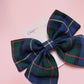 Small tartan hair bow with blue, green, yellow and red tartan. 