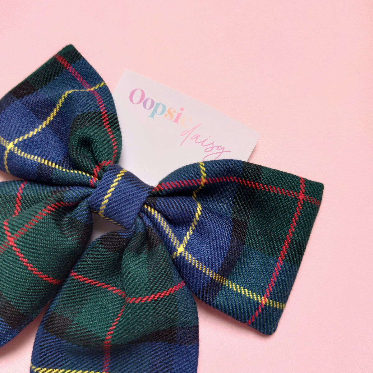 Tartan hair bow in blue and green with yellow and red thin lines.
