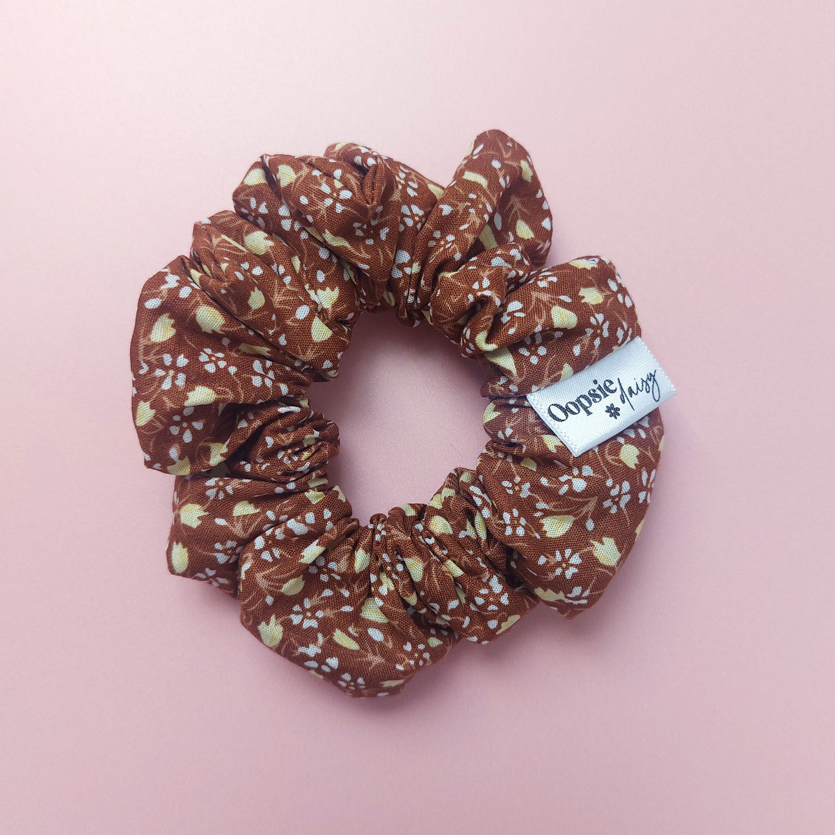 Warm brown scrunchie with small cream floral print. 