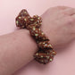 Warm brown scrunchie with small cream floral print. 