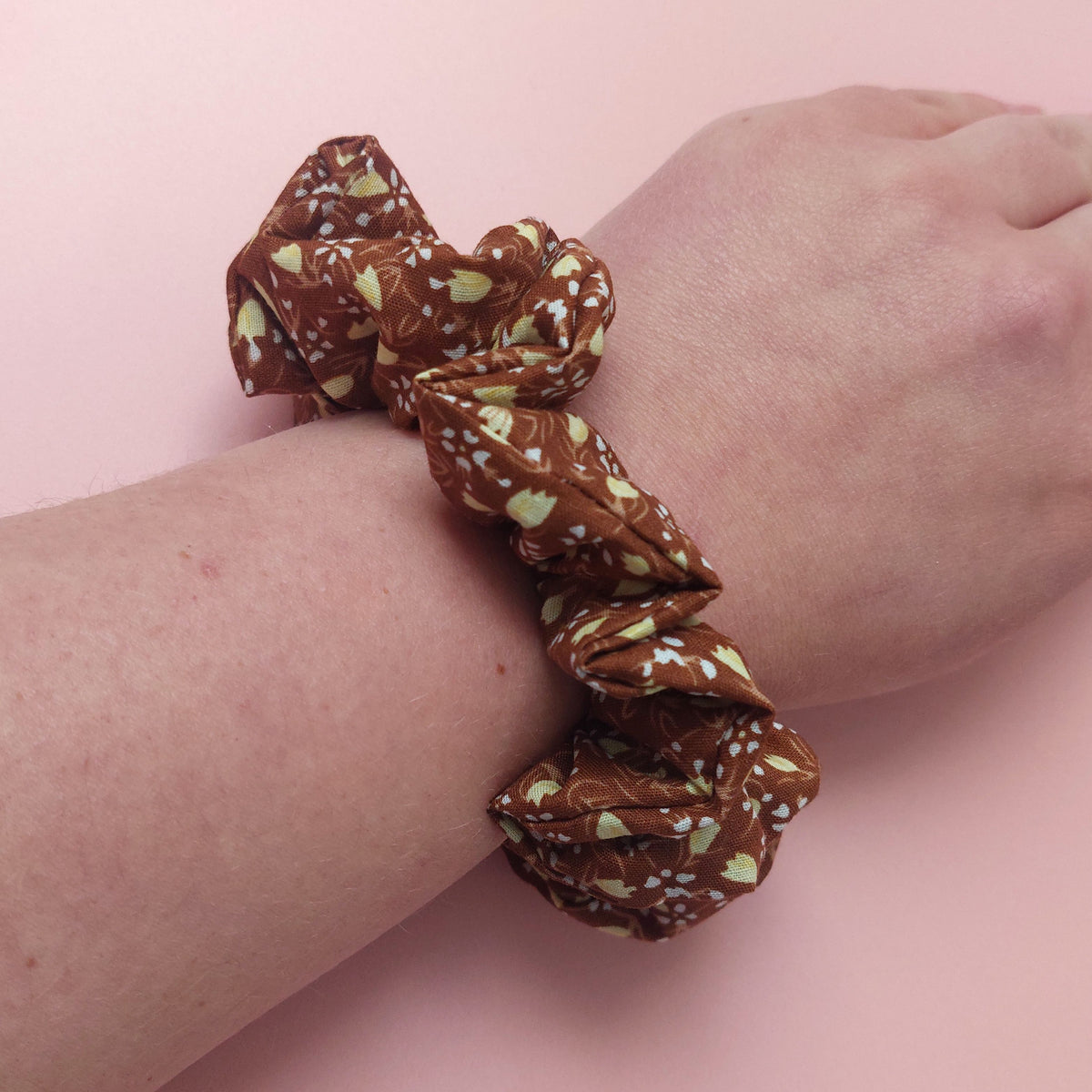 Warm brown scrunchie with small cream floral print. 