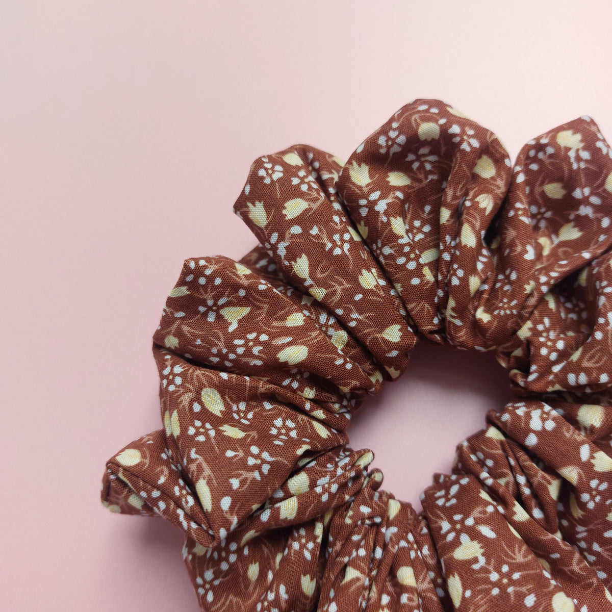 Brown oversized hair scrunchie with small cream ditsy flowers