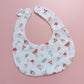 White round shaped baby bib with autumnal pattern of mushrooms, acorns, leaves and autumn flowers. 