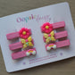 Set of pink clips with butterfly, flower and rainbow