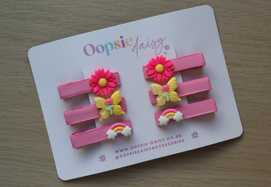 Set of pink clips with butterfly, flower and rainbow