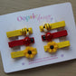 Yellow and red hair sliders with bees and ladybirds
