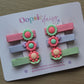 Set of colourful hair clips with 3D floral embellishment. 