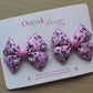 Pair pink hair bows with unicorn design