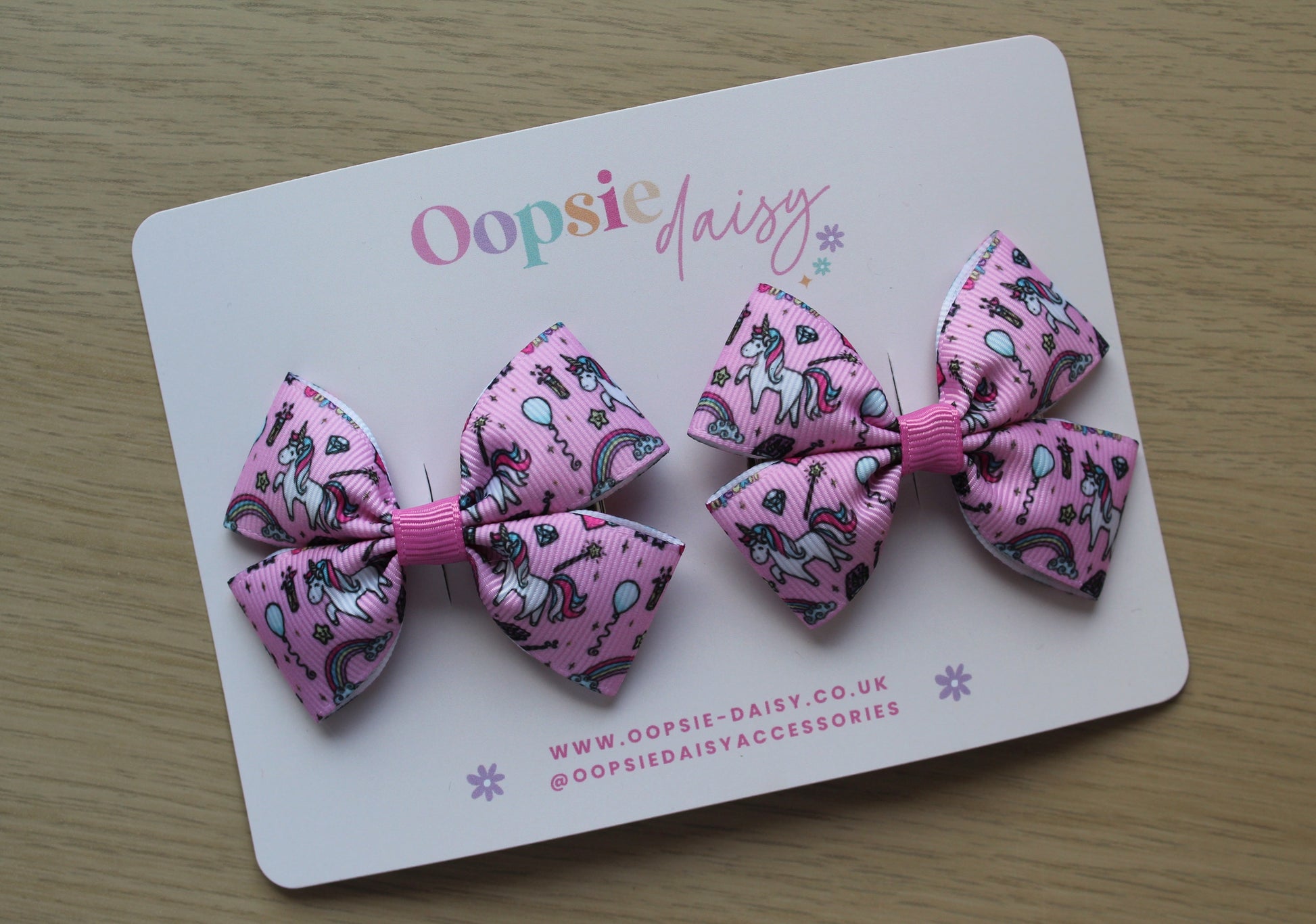 Pair pink hair bows with unicorn design