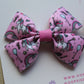 Pink hair bow with unicorn design