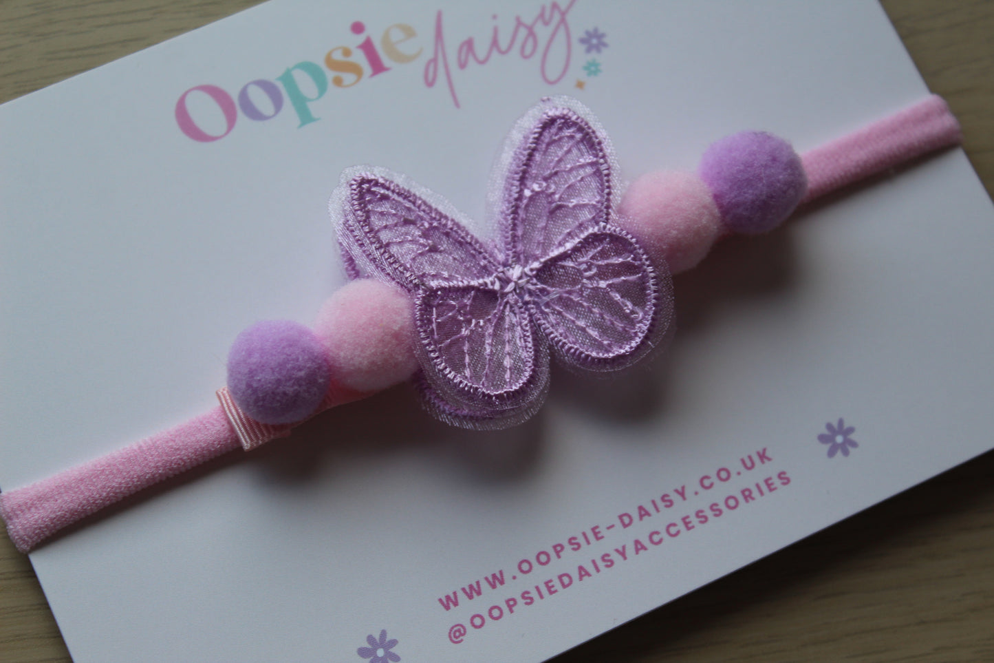 Pink and purple butterfly and pom pom baby headband
